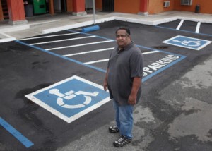 Vikas Patel, owner of the EconoLodge in Santa Clara, Calif., shows Thursday, Feb. 6, 2014 the handicapped parking he added after being sued for alleged ADA violations. He paid $20,000 to defend himself against serial ADA litigant John Ho, and his San Diego attorney, who have sued numerous South Bay mom and pop businesses for alleged ADA violations. (Karl Mondon/Bay Area News Group)